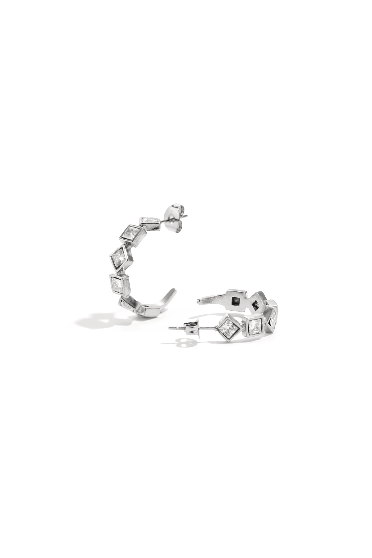 Pair of silver tone square rhinestone hoop earrings displayed on white background