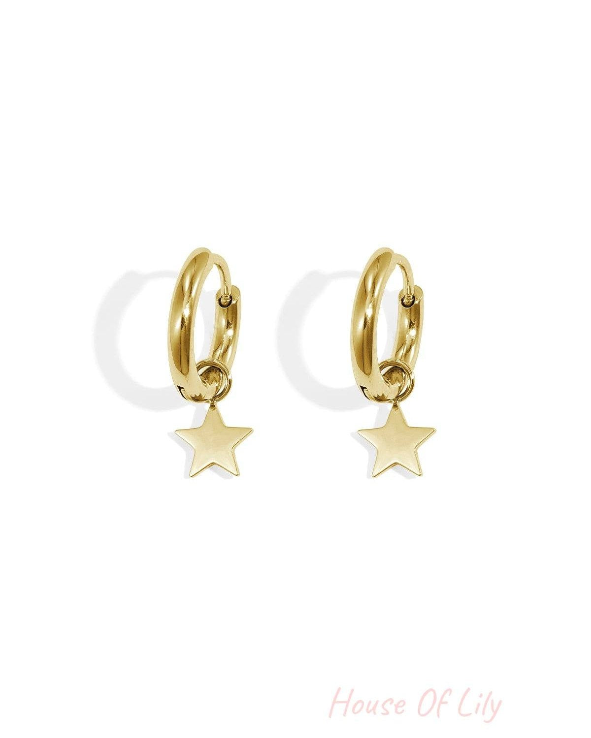 Pair of gold hoop earrings with dangling star charms on white background