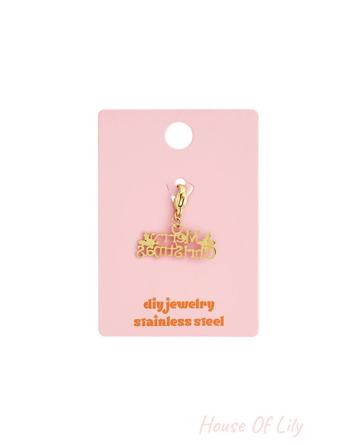 Gold-tone stainless steel "Merry Christmas" charm with lobster clasp on a pink display card.