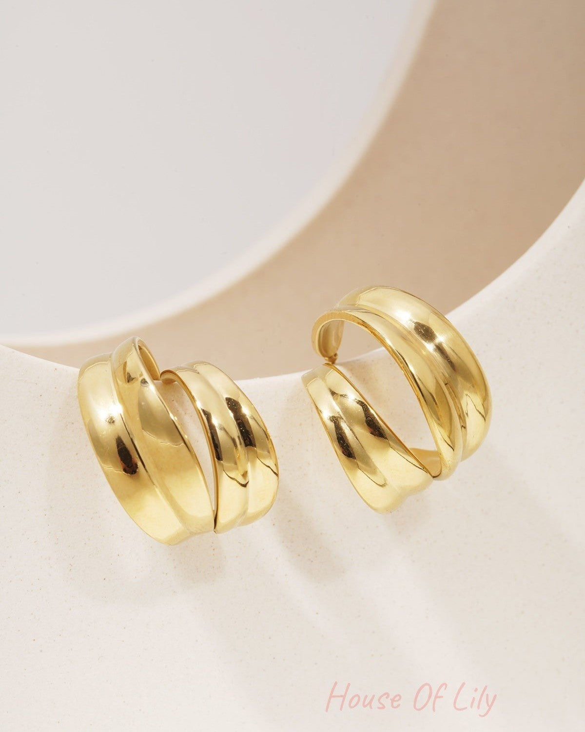 Sculpted Aura Loops: Pair of chunky, gold-plated open hoop earrings with a polished, sculptural, double-layered design.