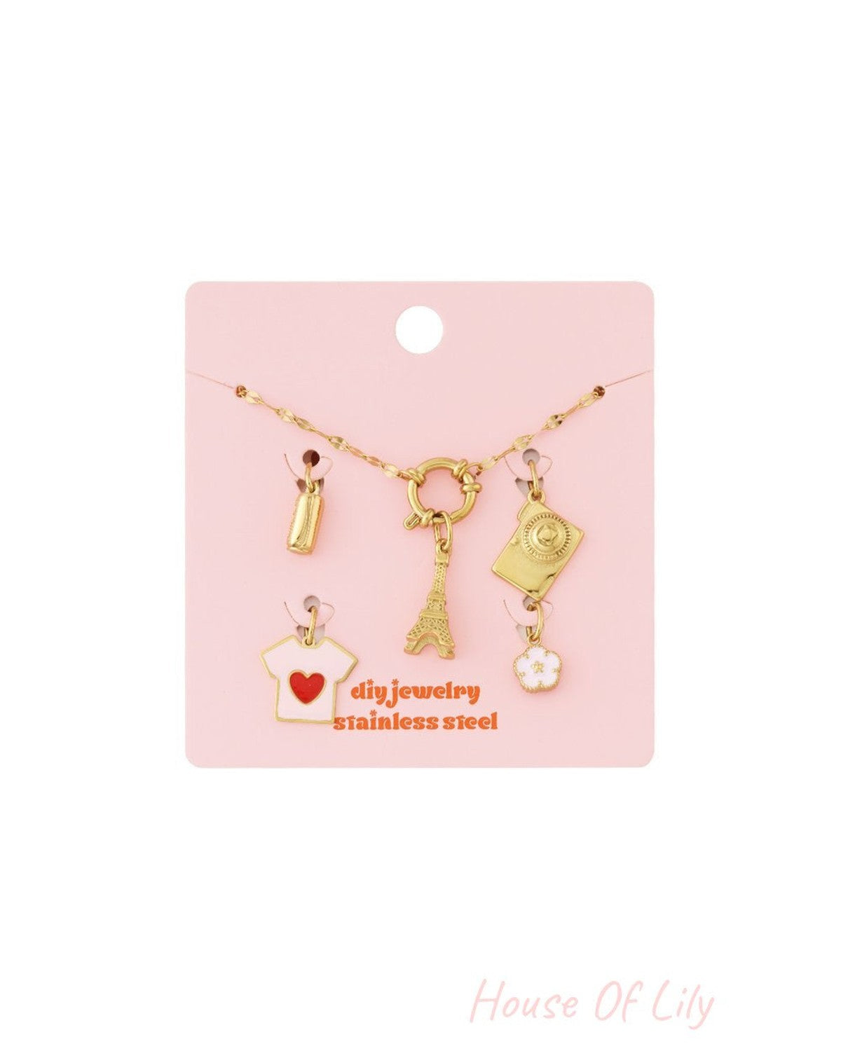 Gold stainless steel chain bracelet kit with assorted Eiffel Tower, camera, heart shirt, and flower charms on pink card.
