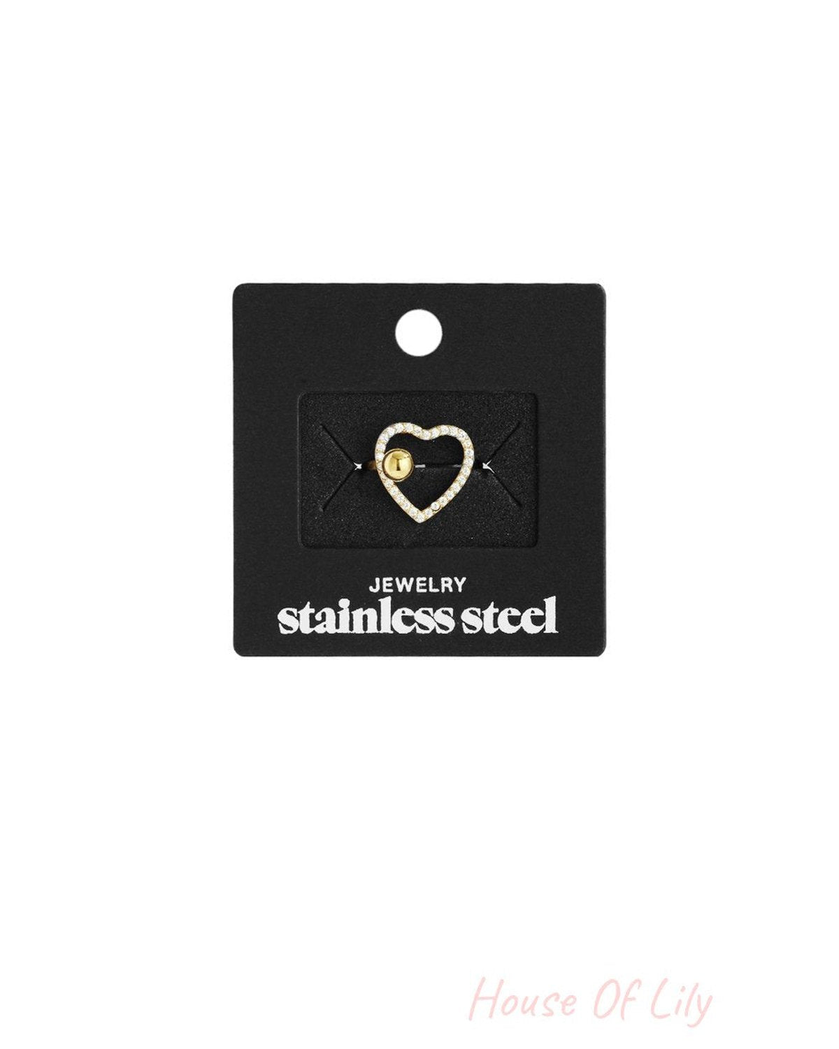 Main Character Heart stainless steel ring featuring a pavΓ©-style crystal heart with a central gold ball accent.