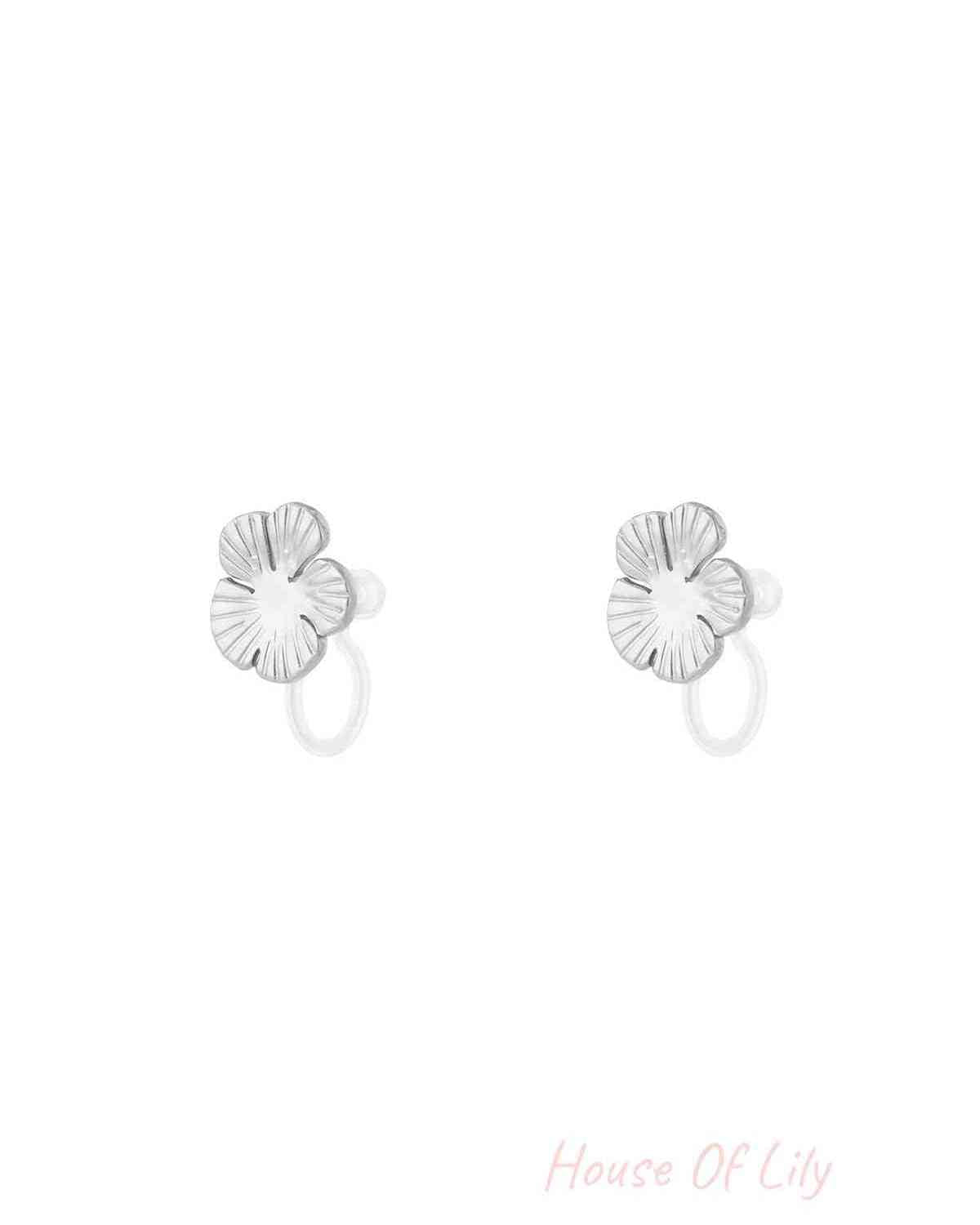 Pair of silver-finished floral clip-on earrings displayed on white background