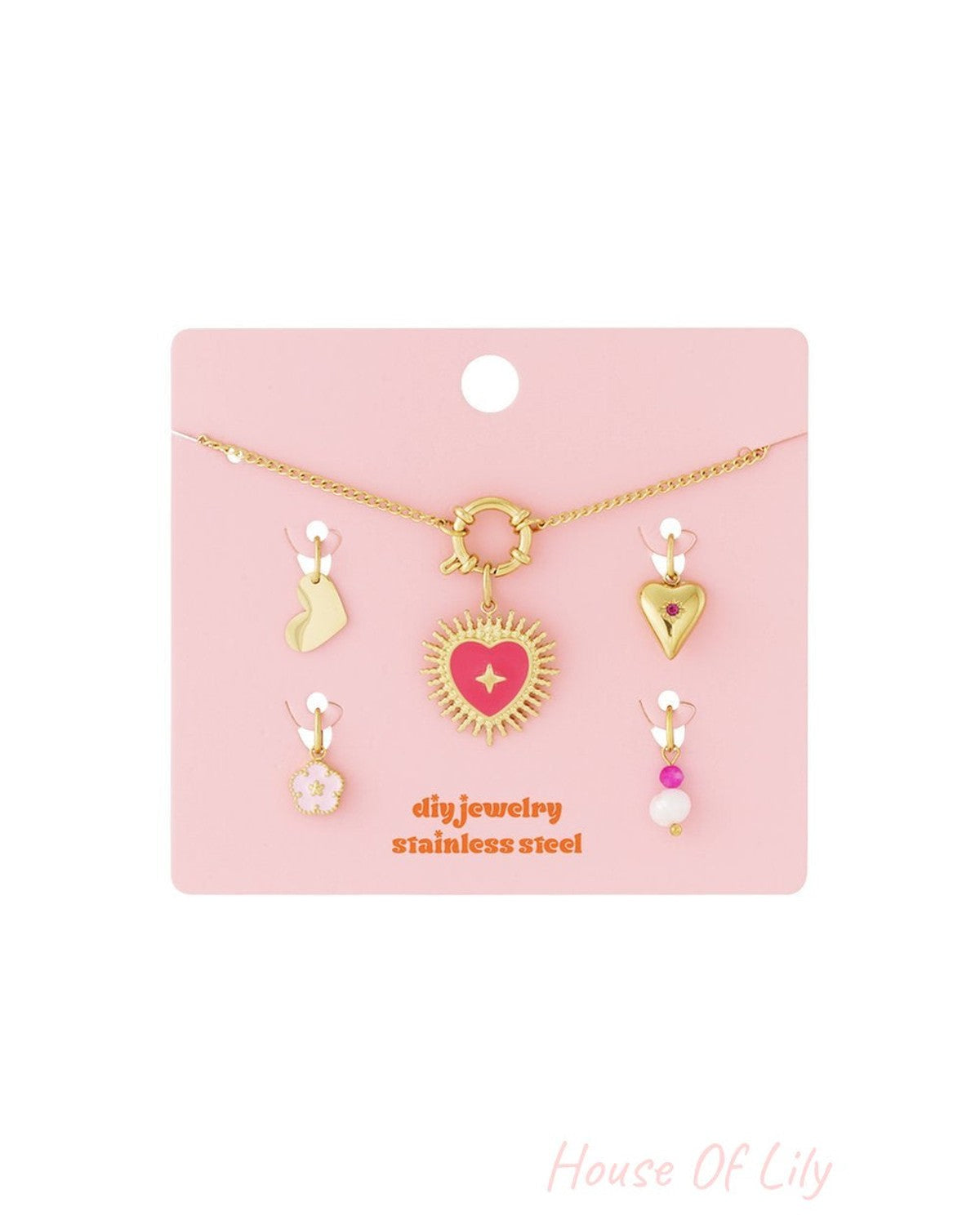 Gold-tone chain DIY jewelry kit with Puffy Heart pendant and four interchangeable charms on a pink display card.