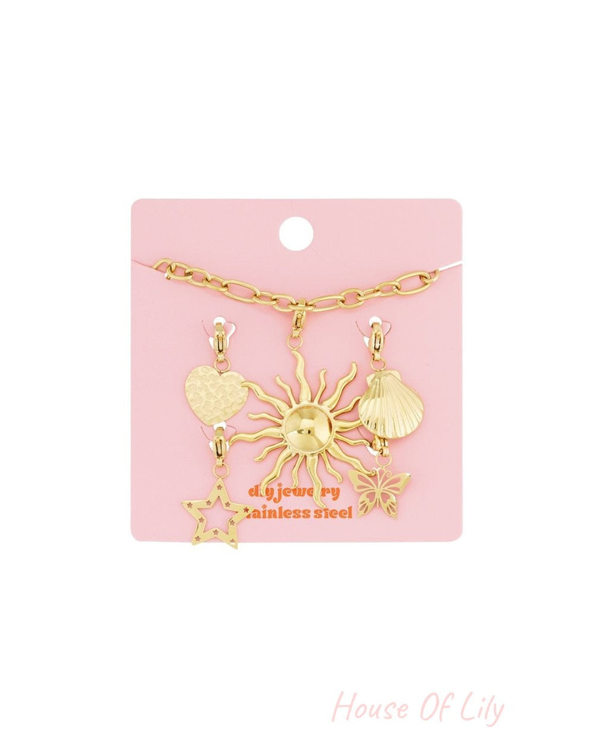 Gold stainless steel charm bracelet featuring sun, star, heart, shell, and butterfly pendants on a pink display card.