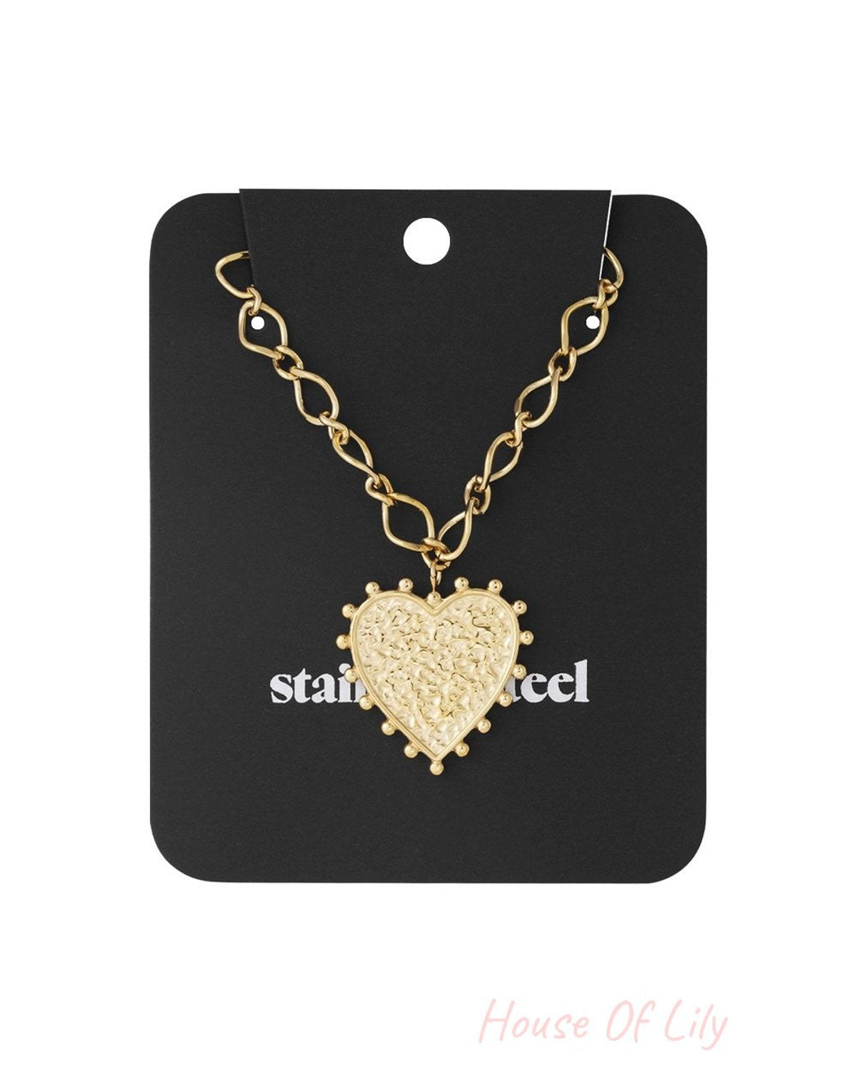 Gold heart necklace with a textured pendant on a linked chain, displayed on a black stainless steel backing card.