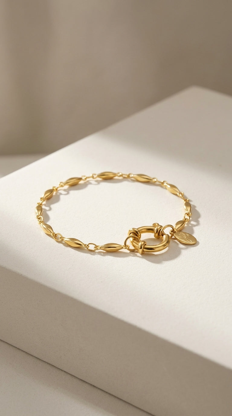 Gold oval chain bracelet with a polished finish and a round spring-ring clasp.