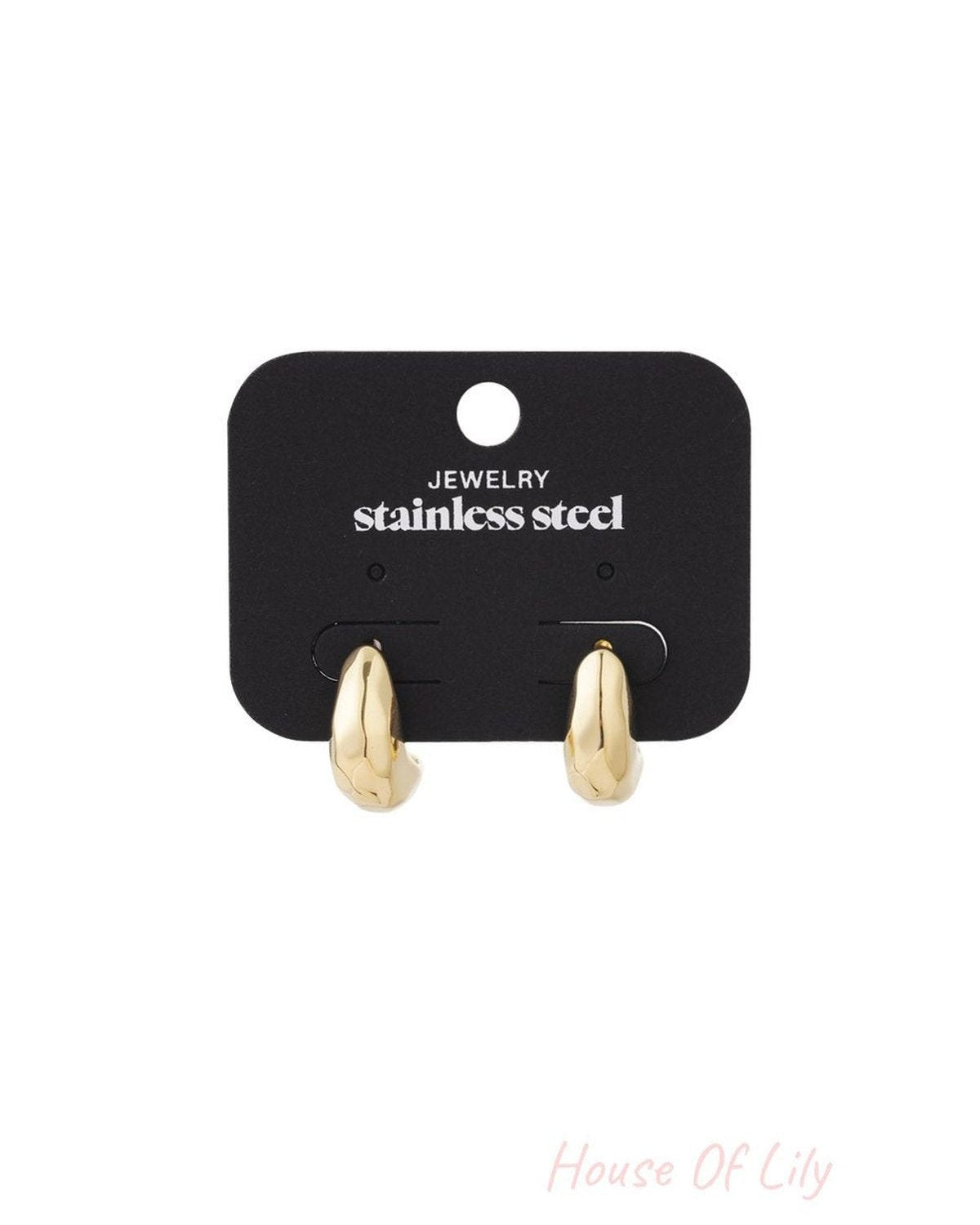 Lunar Glitch gold stainless steel small hoop earrings with a textured, organic melted shape on a black display card.