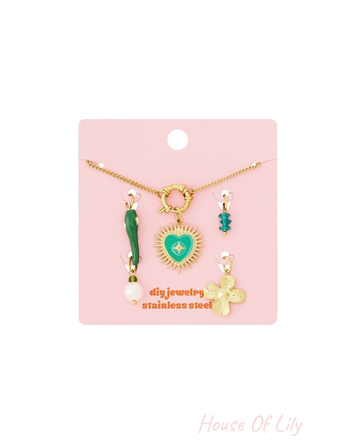 Gold-tone link bracelet kit on pink card with heart, flower, pearl, and crystal charms, stainless steel.