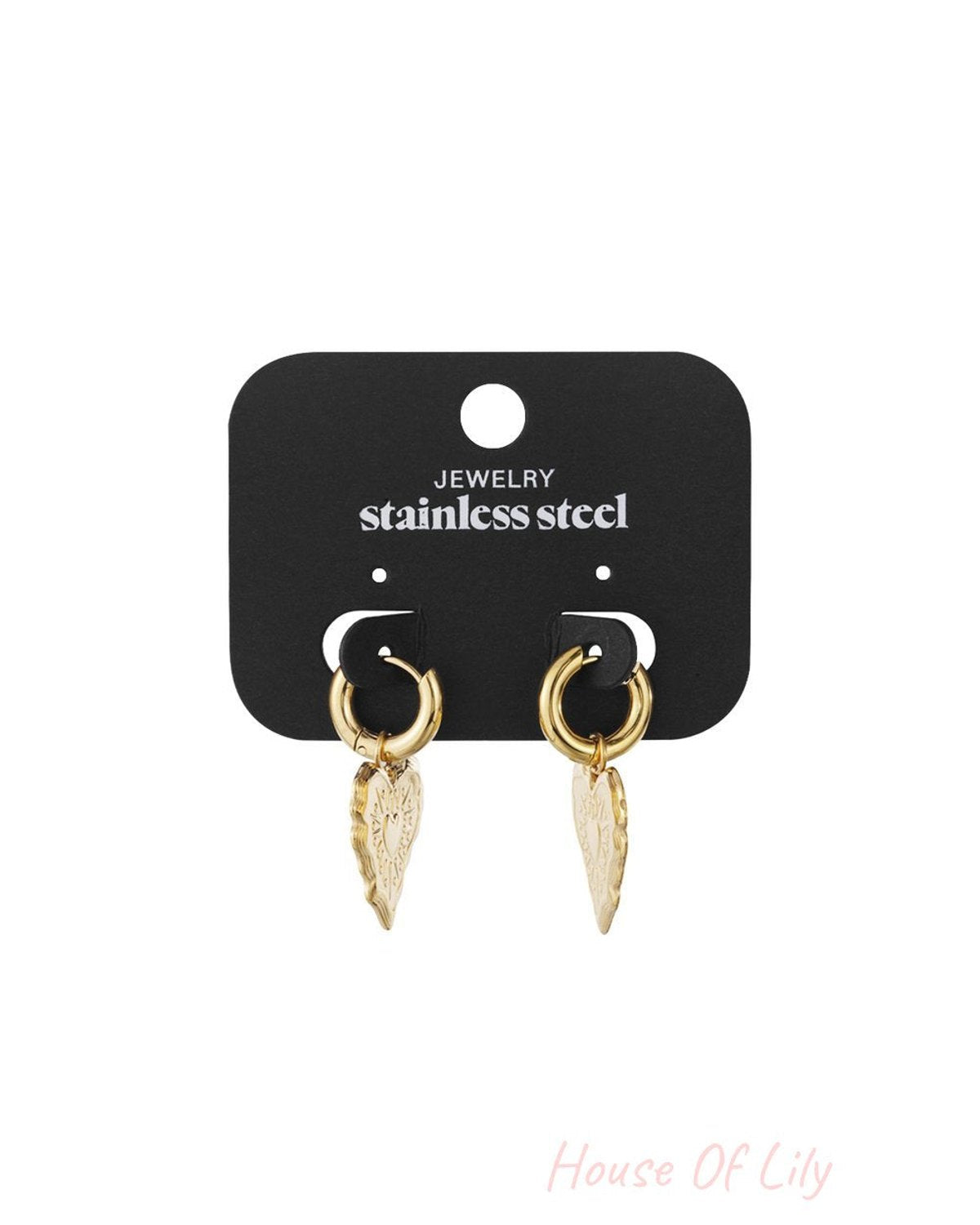 Gold stainless steel hoop earrings with engraved heart pendants on a display card.