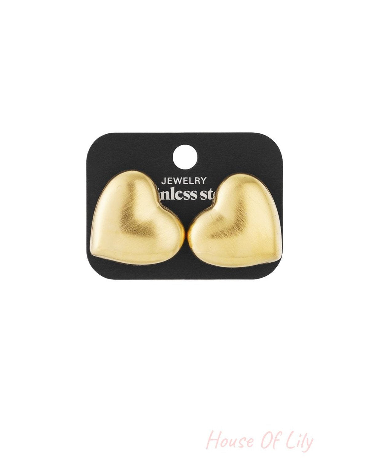 Softie Heart Stacks: A pair of puffy, matte gold heart-shaped stud earrings on a black display card.