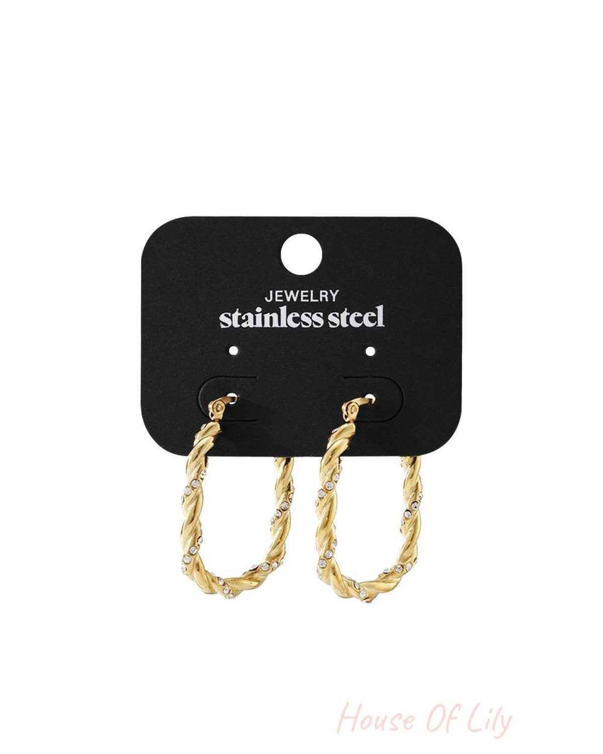 Gold-tone twisted stainless steel hoop earrings featuring embedded clear crystals on a black display card.