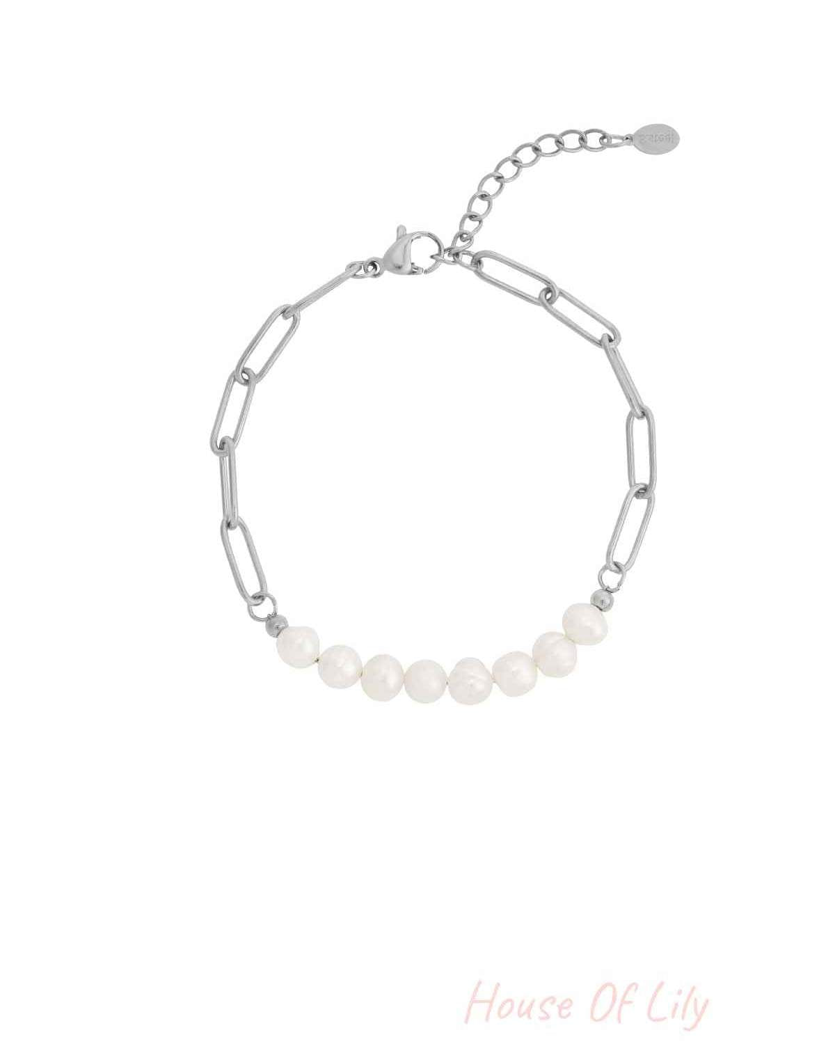 Silver chain bracelet with rectangular links featuring a row of seven white freshwater pearls and a lobster clasp with extender chain