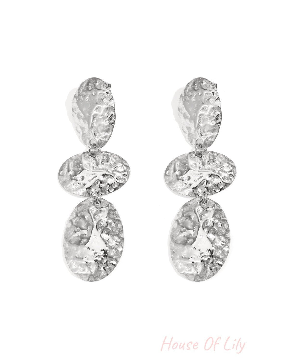 Pair of hammered silver oval dangle earrings with three connected textured oval shapes displayed on white background