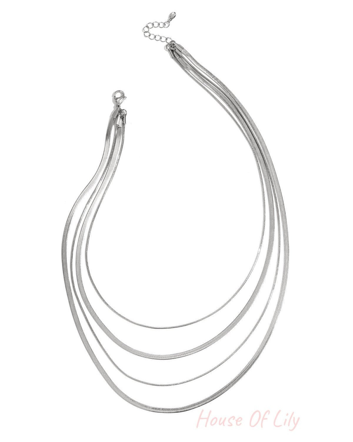 Four-strand silver layered necklace on white background with lobster clasp