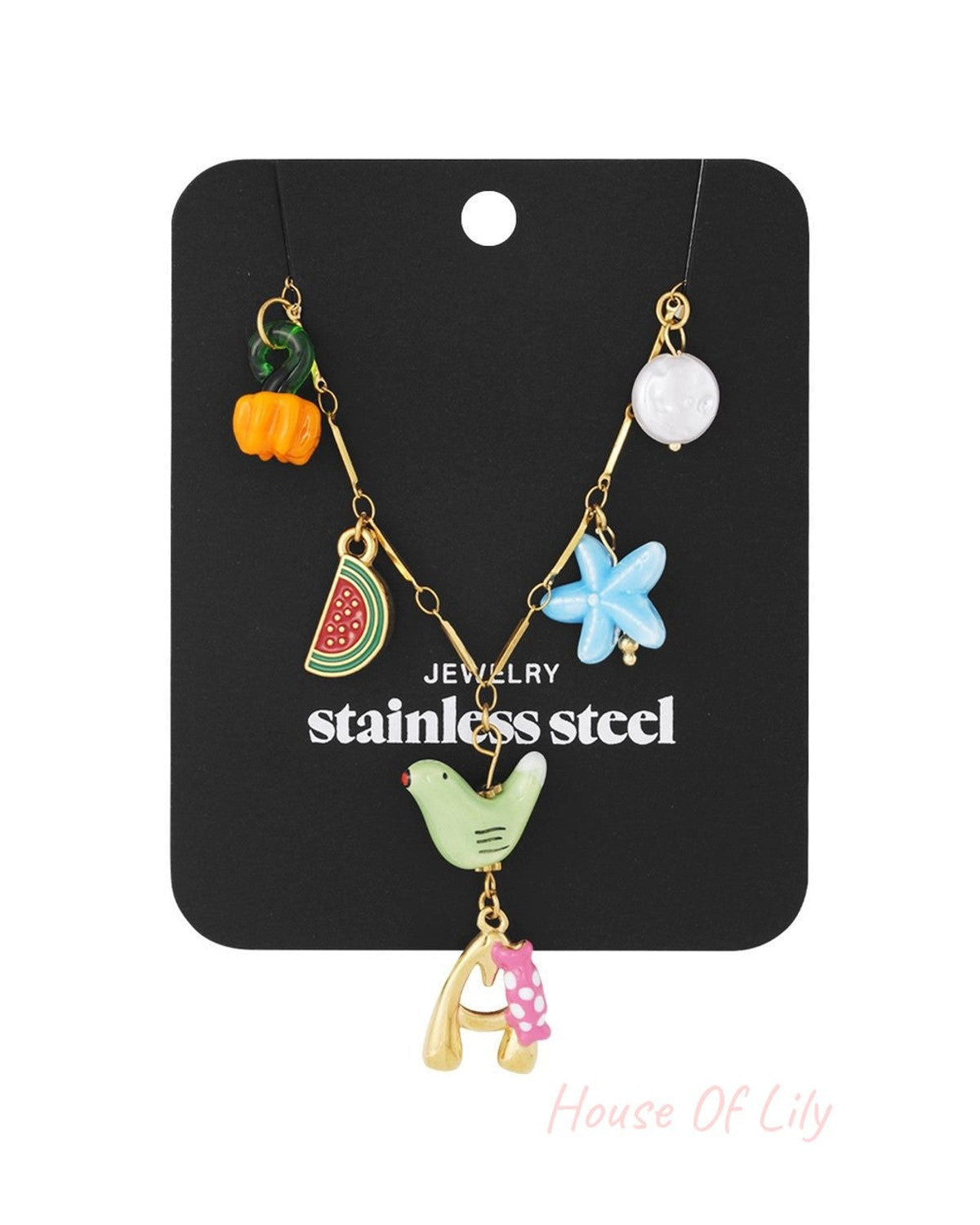Gold stainless steel charm necklace featuring a letter "A" pendant, bird, watermelon slice, flower, and assorted beads.