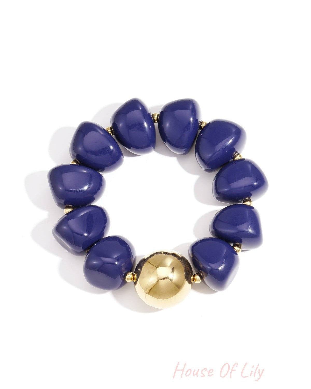 Close-up of chunky blue acrylic beaded bracelet featuring a shiny gold bead