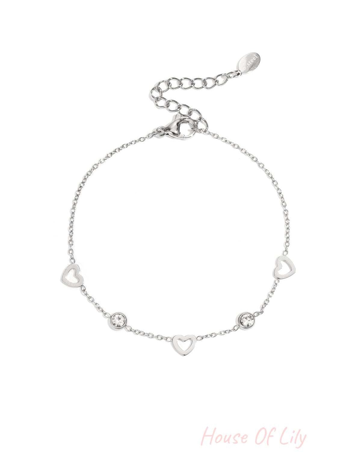 Silver delicate chain bracelet with open heart charms and small clear rhinestones on a white background