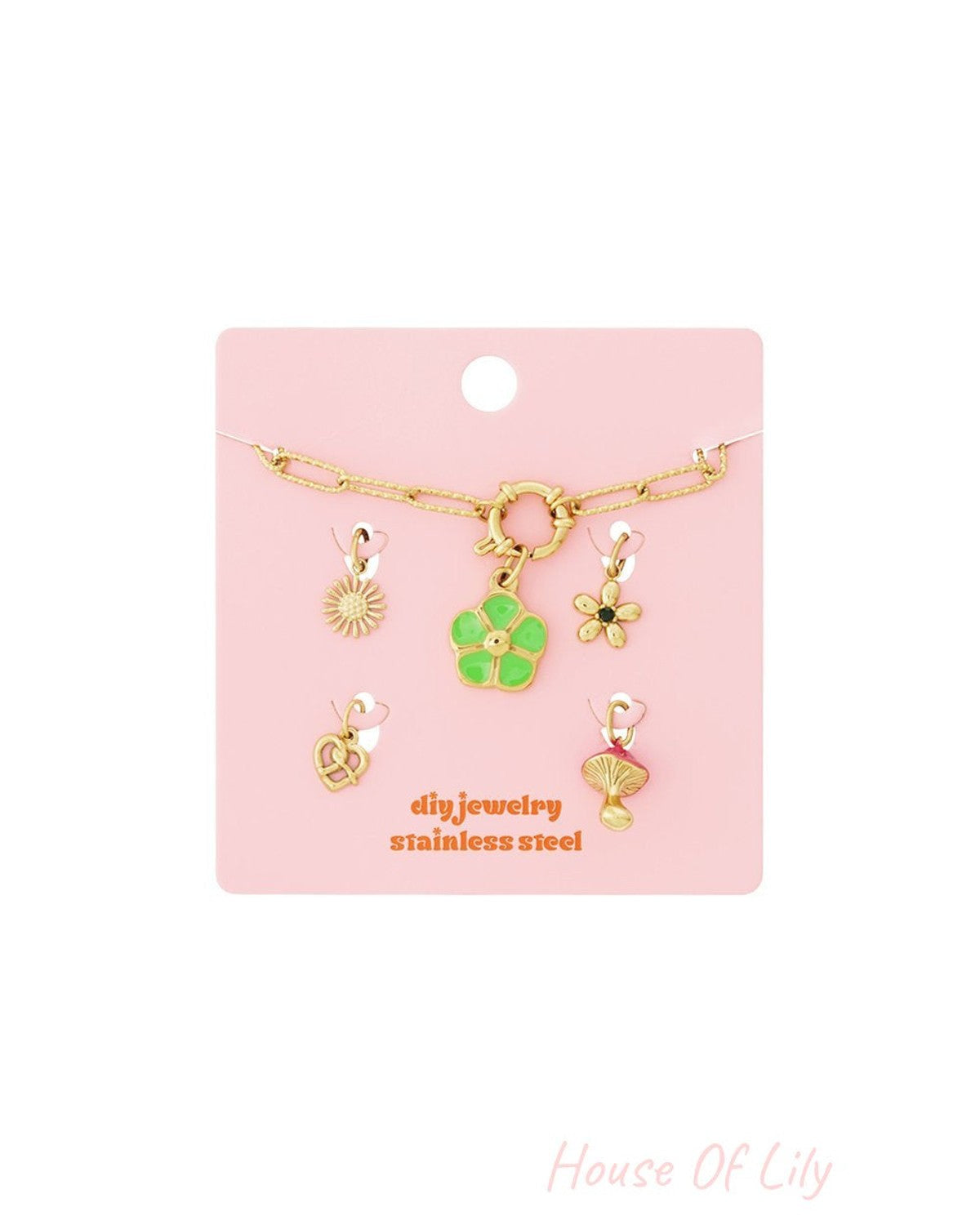 Gold-tone stainless steel DIY jewelry set with a chain and five charms: sun, green flower, small flower, pretzel, mushroom.