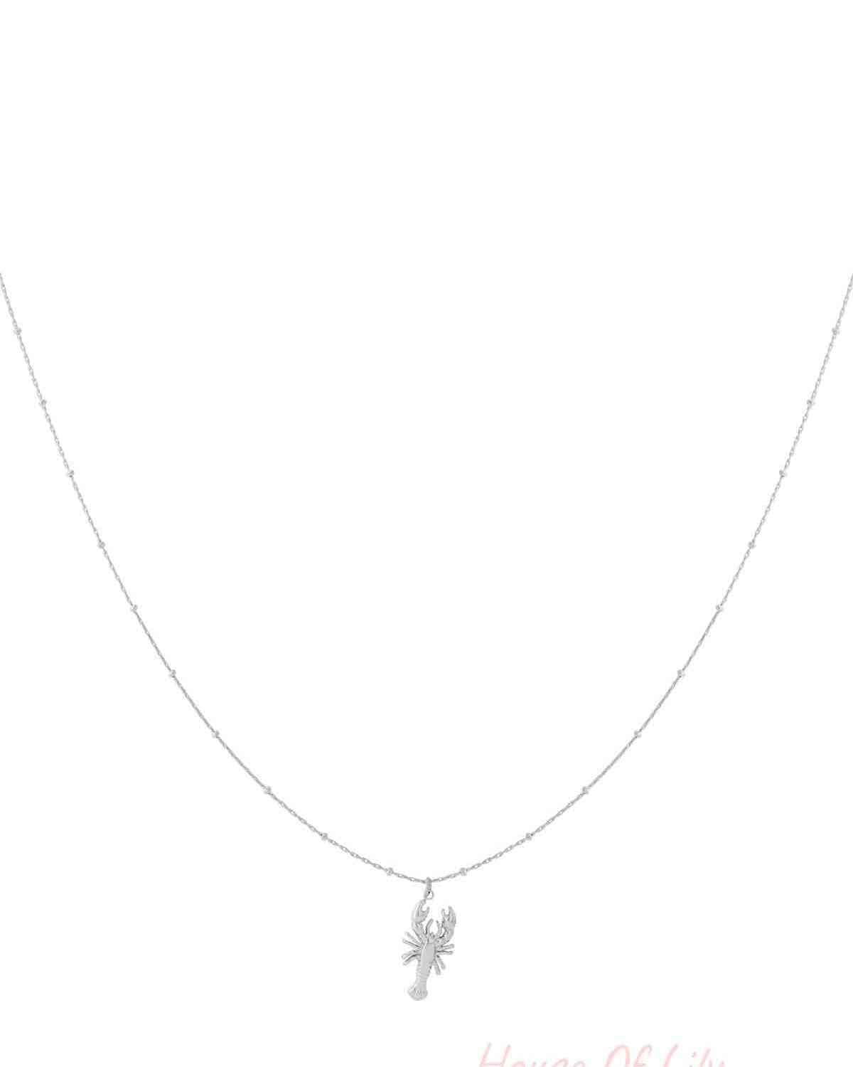Silver delicate lobster pendant necklace on a thin beaded chain isolated on white background