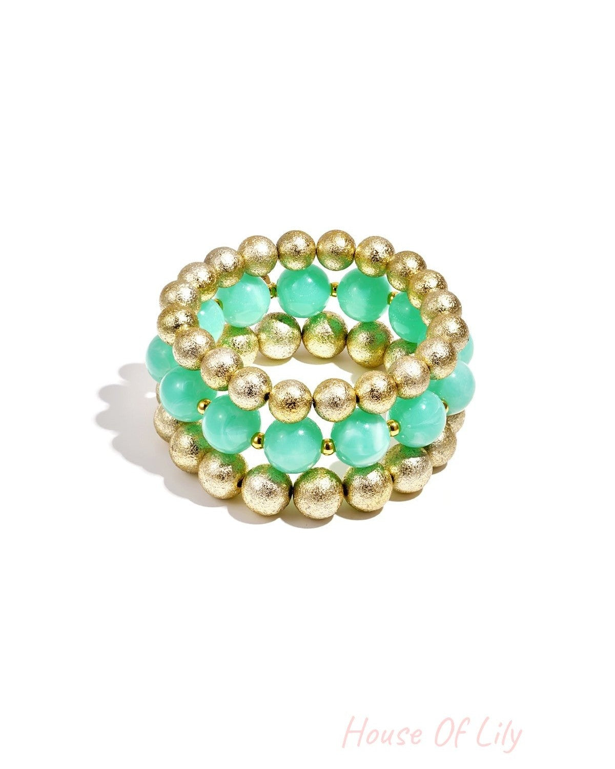 Trio of stretch bracelets featuring alternating mint green translucent beads and textured gold metallic beads.