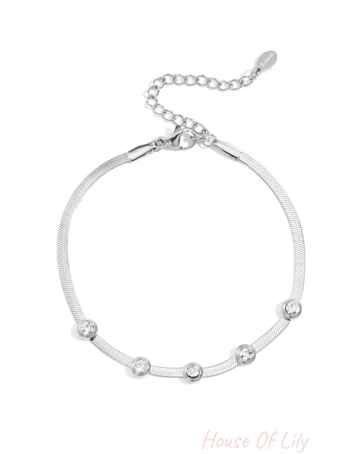 Silver-tone chain bracelet featuring five clear rhinestones with adjustable lobster clasp on white background