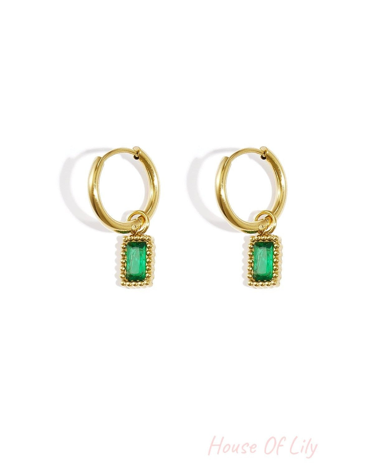 Pair of gold hoop earrings with green rectangular gemstone charms on a white background