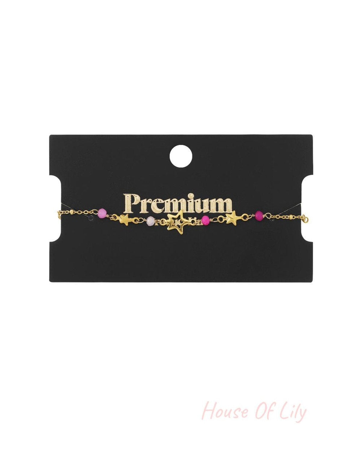 Gold-tone star charm bracelet with pink and white beads on a black retail display card.