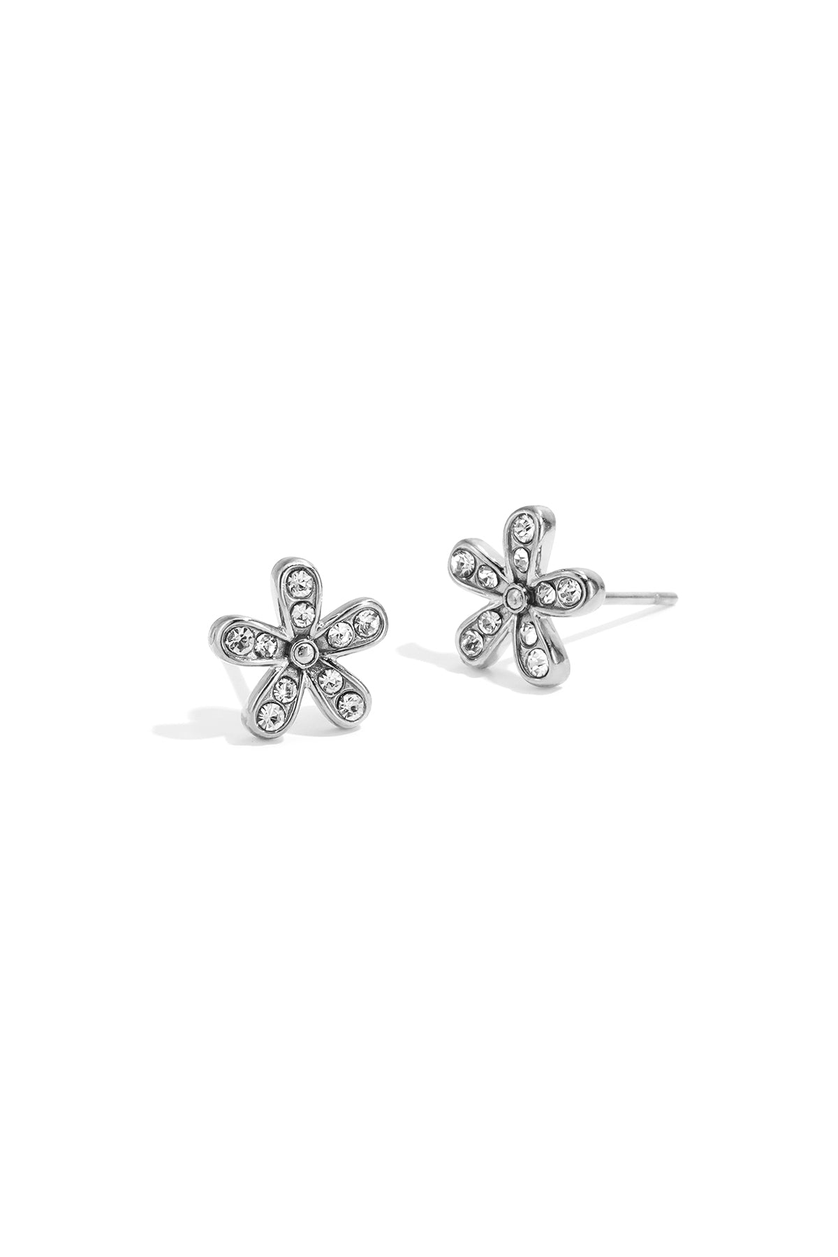 Close-up of silver flower stud earrings with clear rhinestones on each petal, isolated on white background