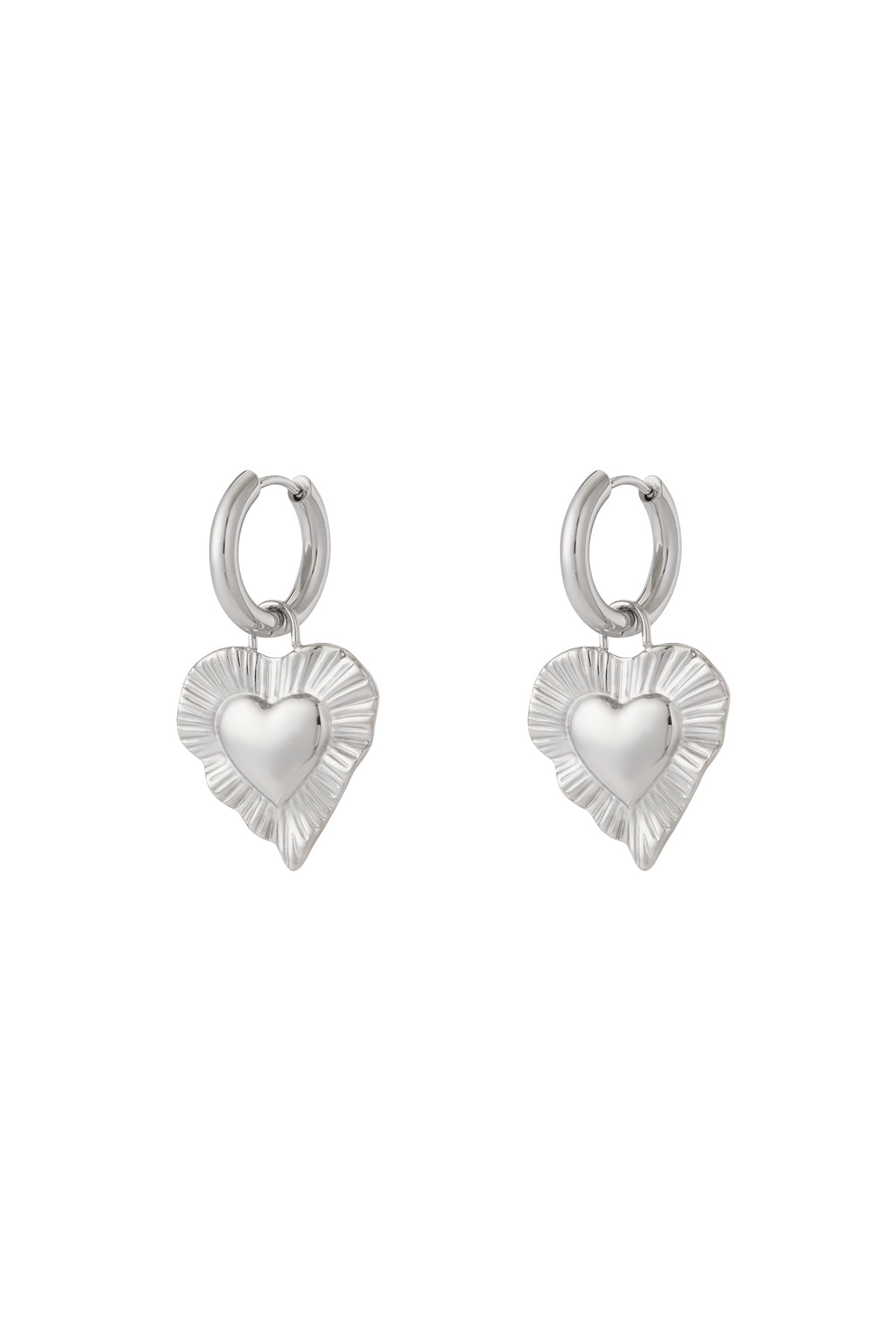 Pair of silver drop earrings with radiant heart-shaped charms featuring a textured fluted border on white background.