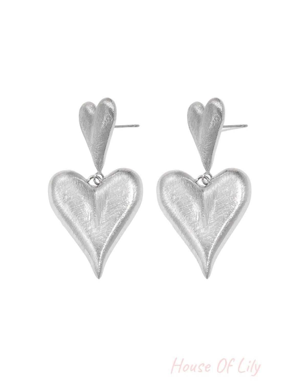 Pair of silver drop earrings with the same two-heart design and textured matte finish