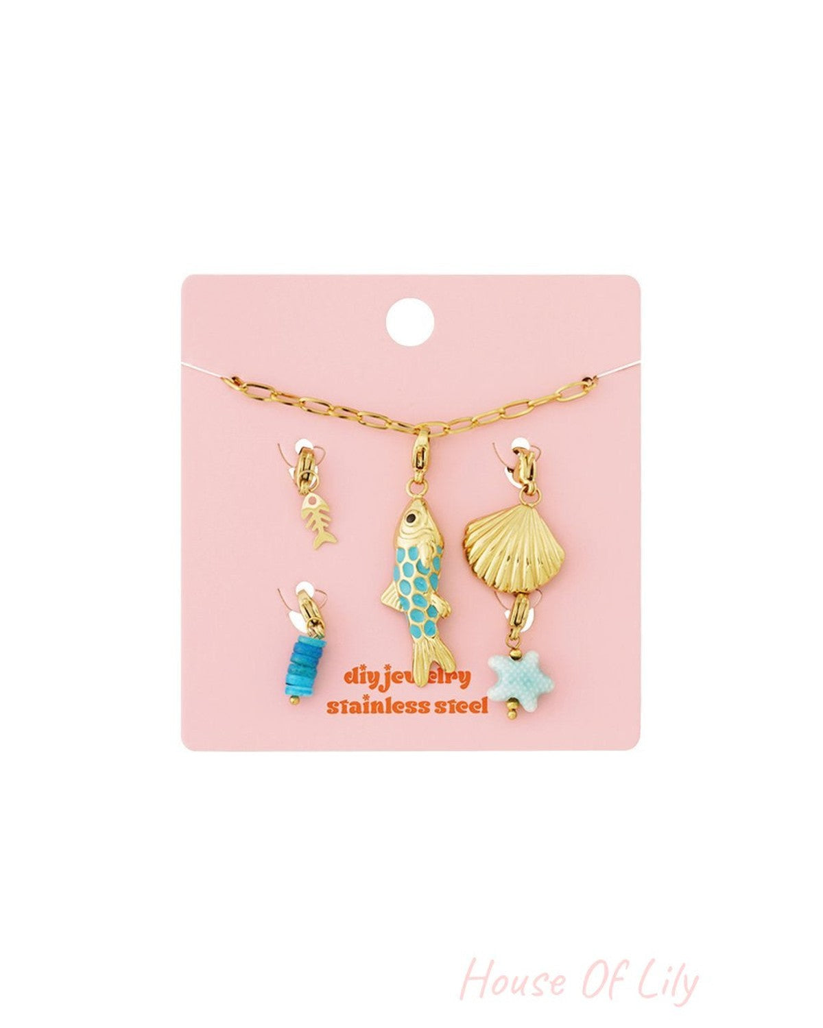 Set of gold-tone ocean-themed stainless steel charms featuring a fish, seashell, starfish, and blue bead accents.