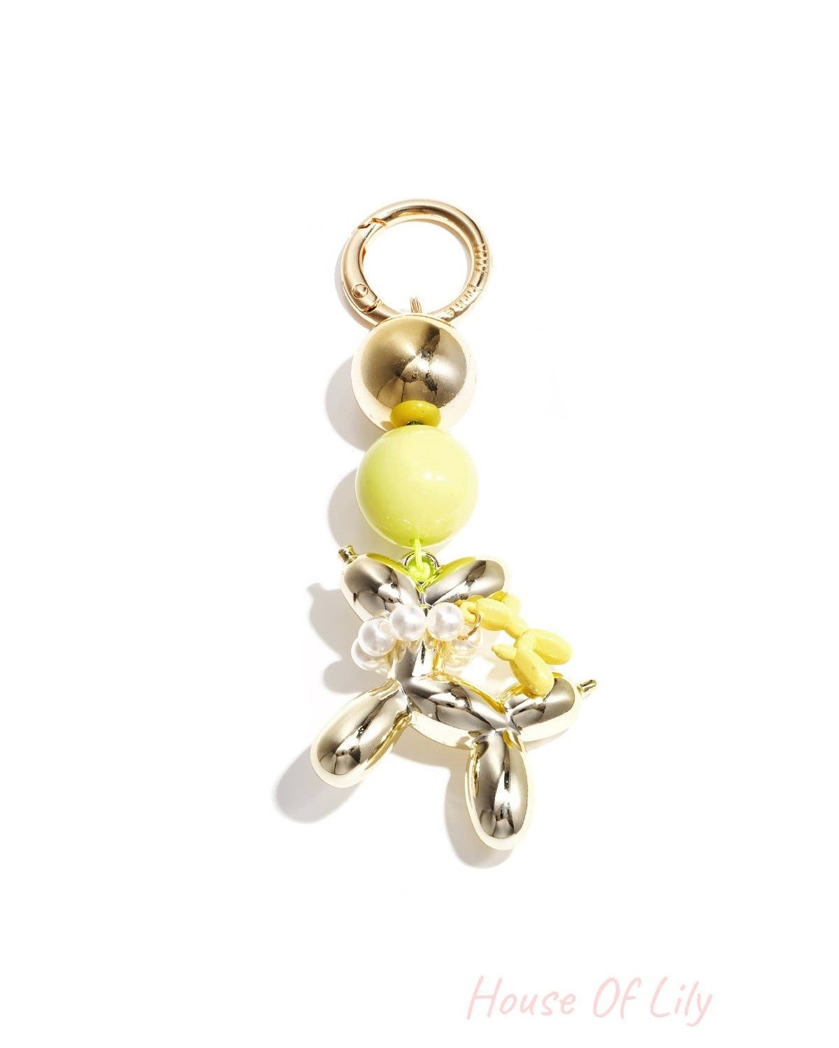 Gold-tone balloon dog keychain with yellow acrylic bead and matching small yellow balloon charm on white background