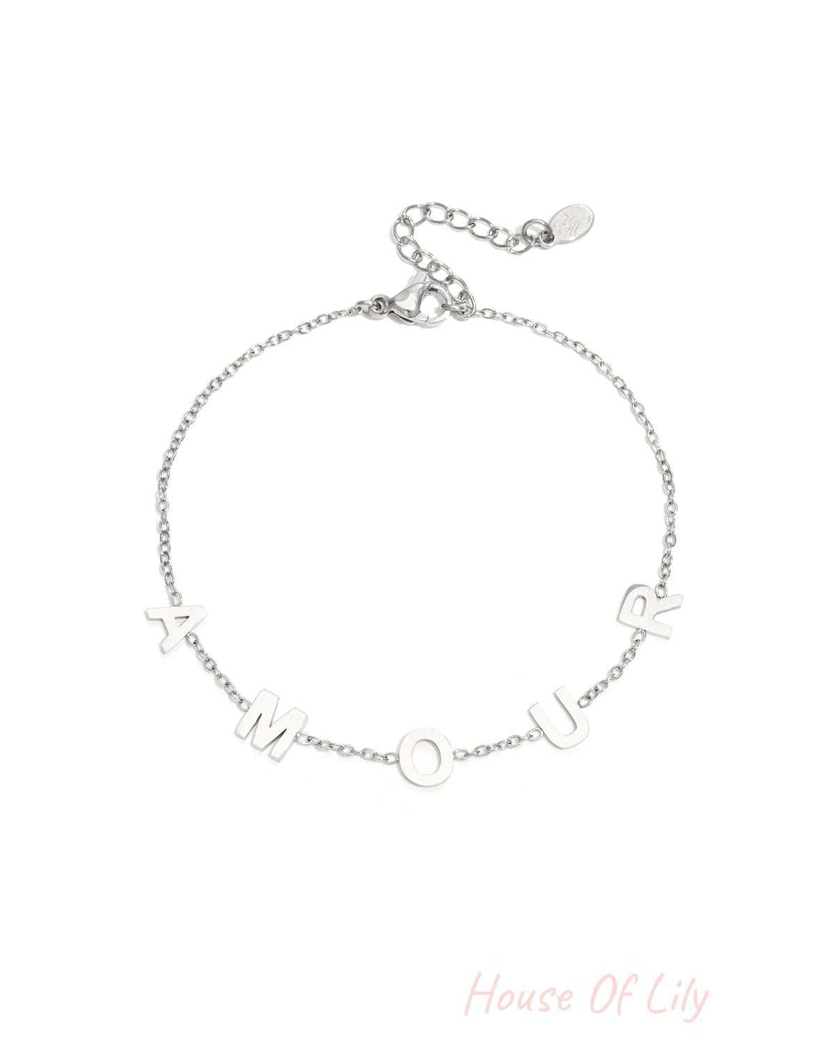 Silver chain bracelet with the letters A M O U R spaced evenly across a delicate link chain and adjustable lobster clasp