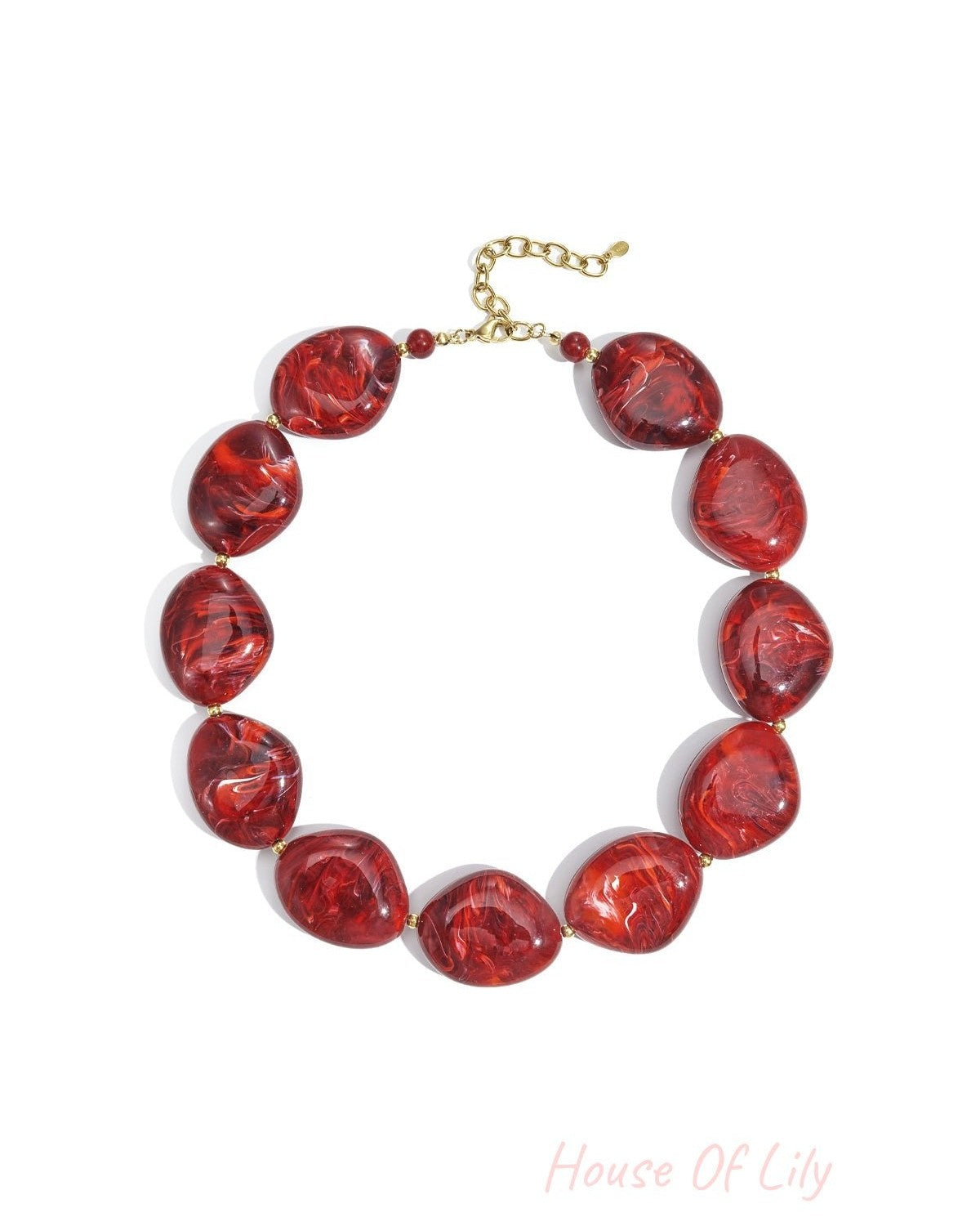 Chunky red marbled acrylic beaded necklace laid flat with gold chain extender