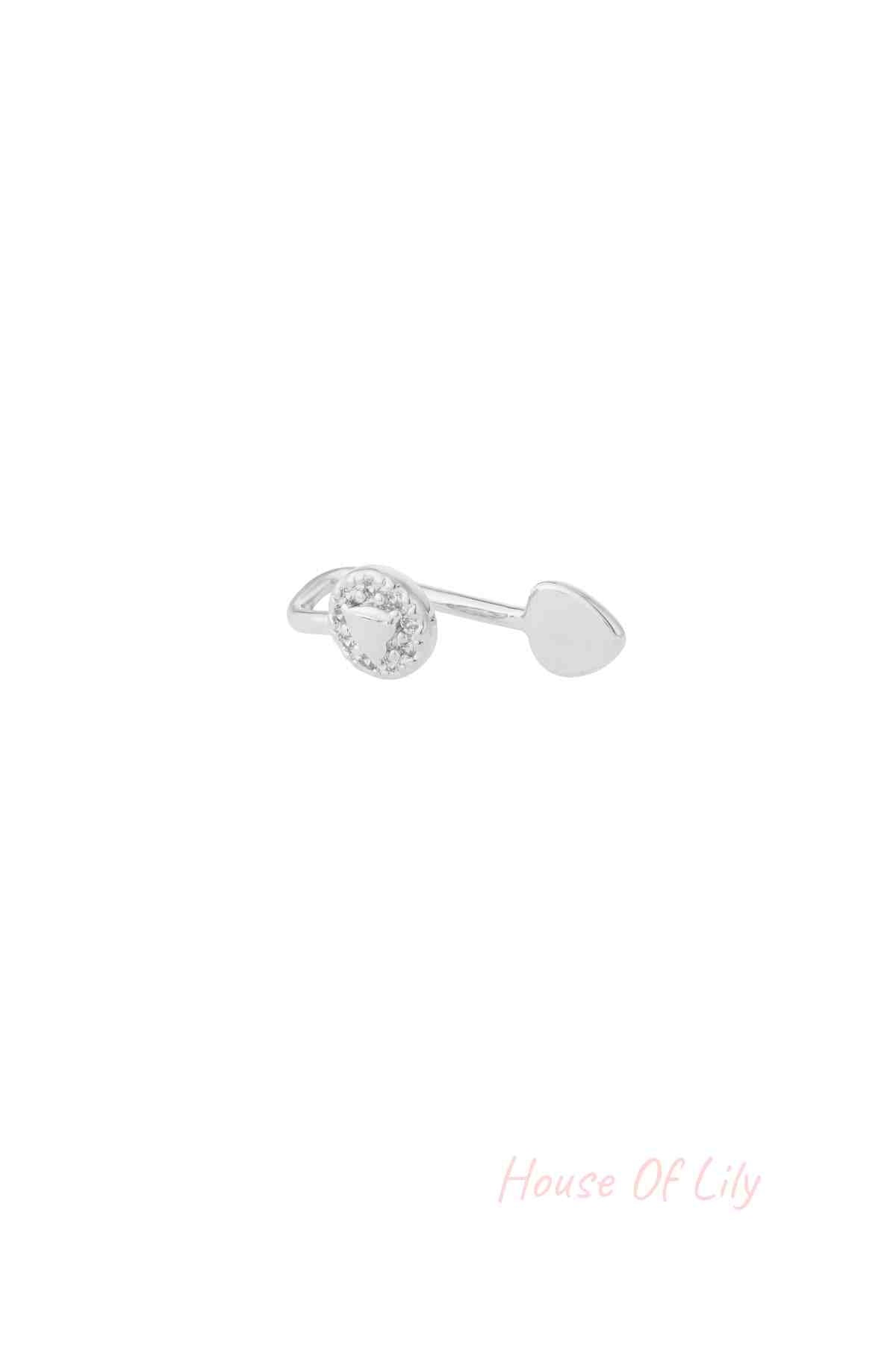 Silver-toned open-ended ear and nose cuff with triangle zircon design and teardrop end on white background
