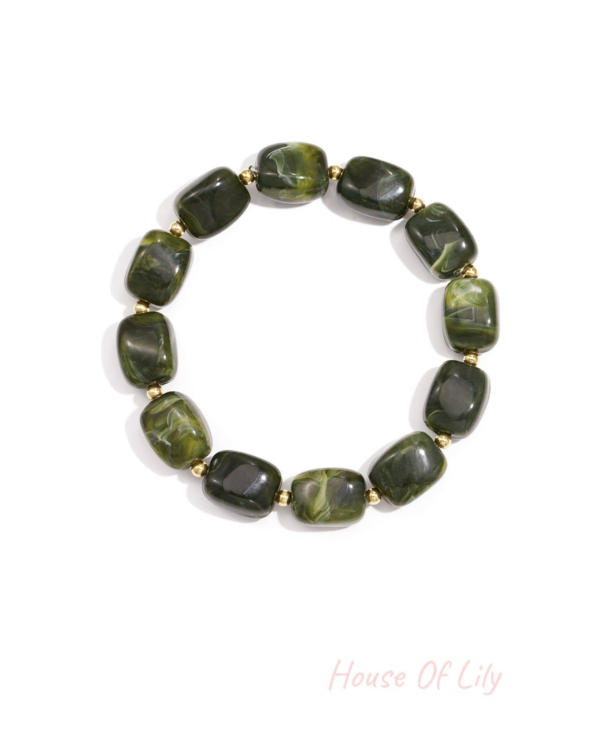 Forest green acrylic chunky bead bracelet with gold spacers on white background with swirled colors