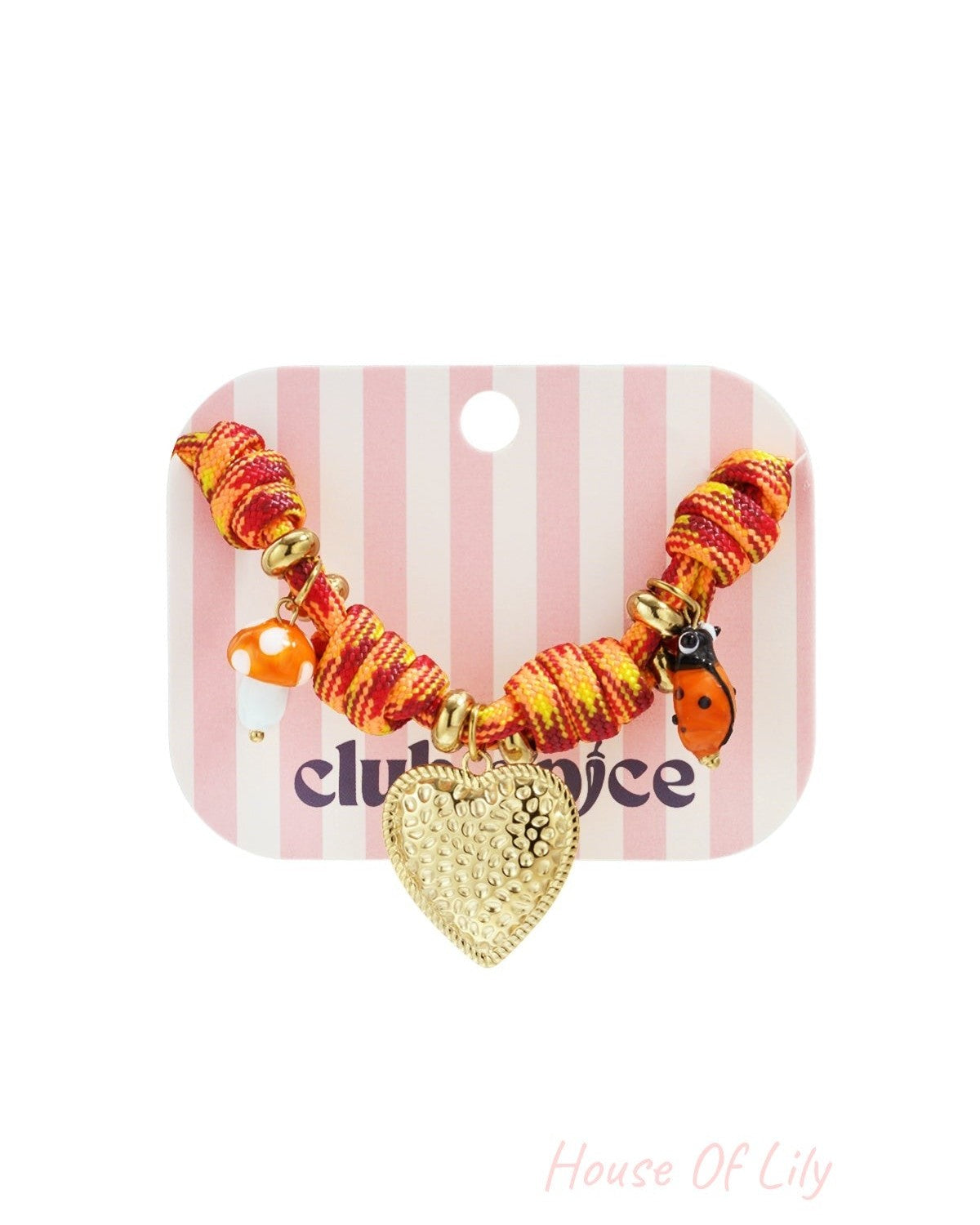 Playful charm bracelet displayed on pink and white striped card featuring gold heart, mushroom, and ladybug charms.