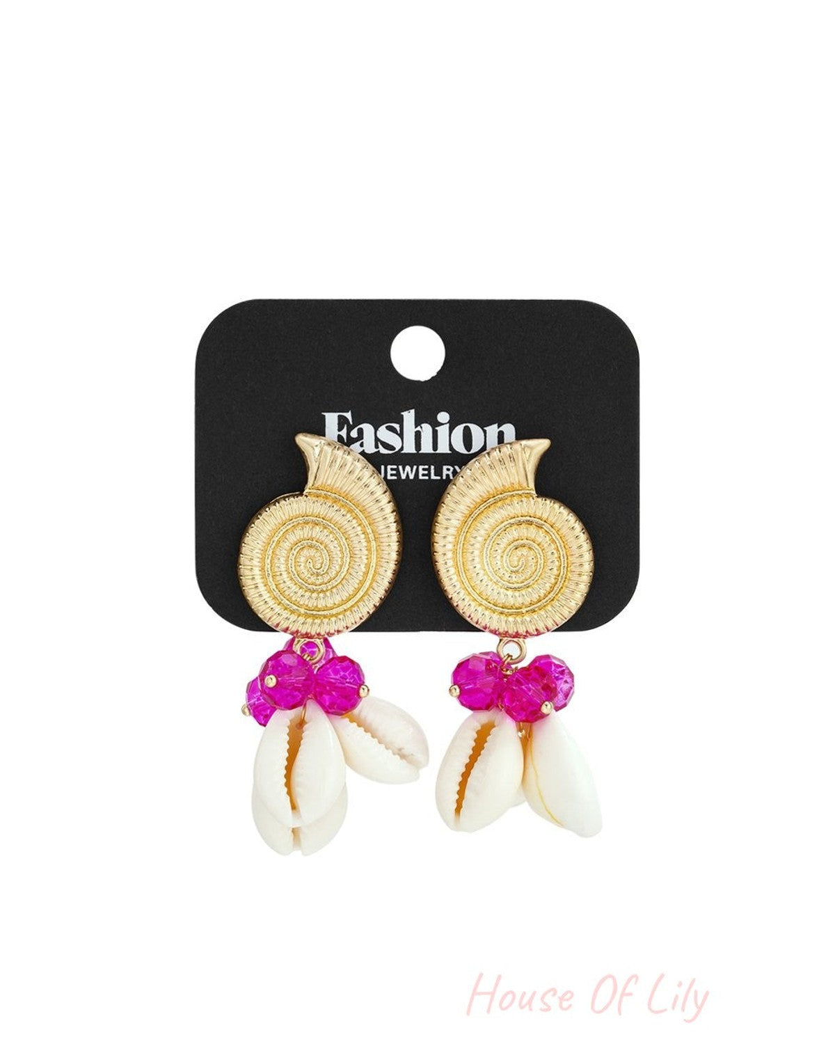 Gold spiral shell earrings with bright pink crystal beads and hanging white cowrie shells on a black display card.