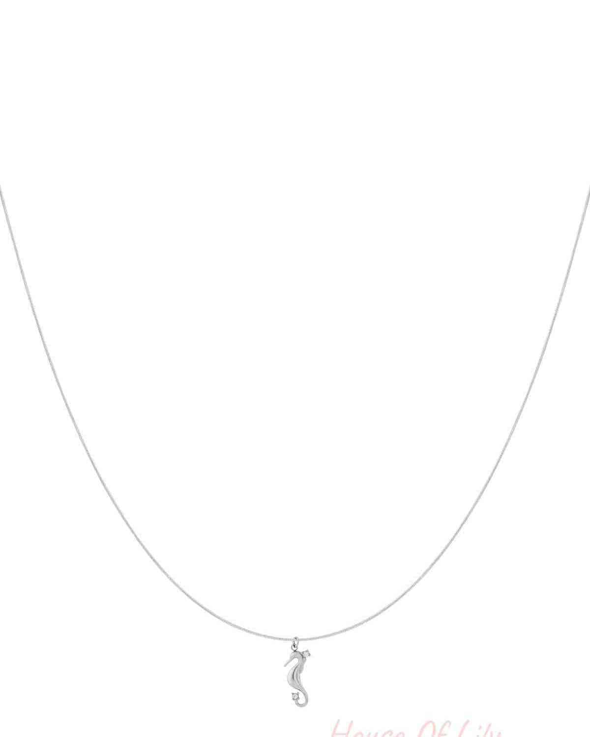 Silver seahorse pendant necklace with rhinestone accents displayed on a white background