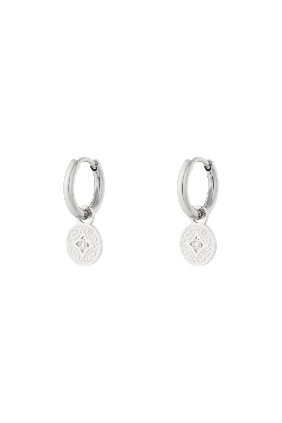 Silver-tone stainless steel hoop earrings with engraved round charm detail on white background
