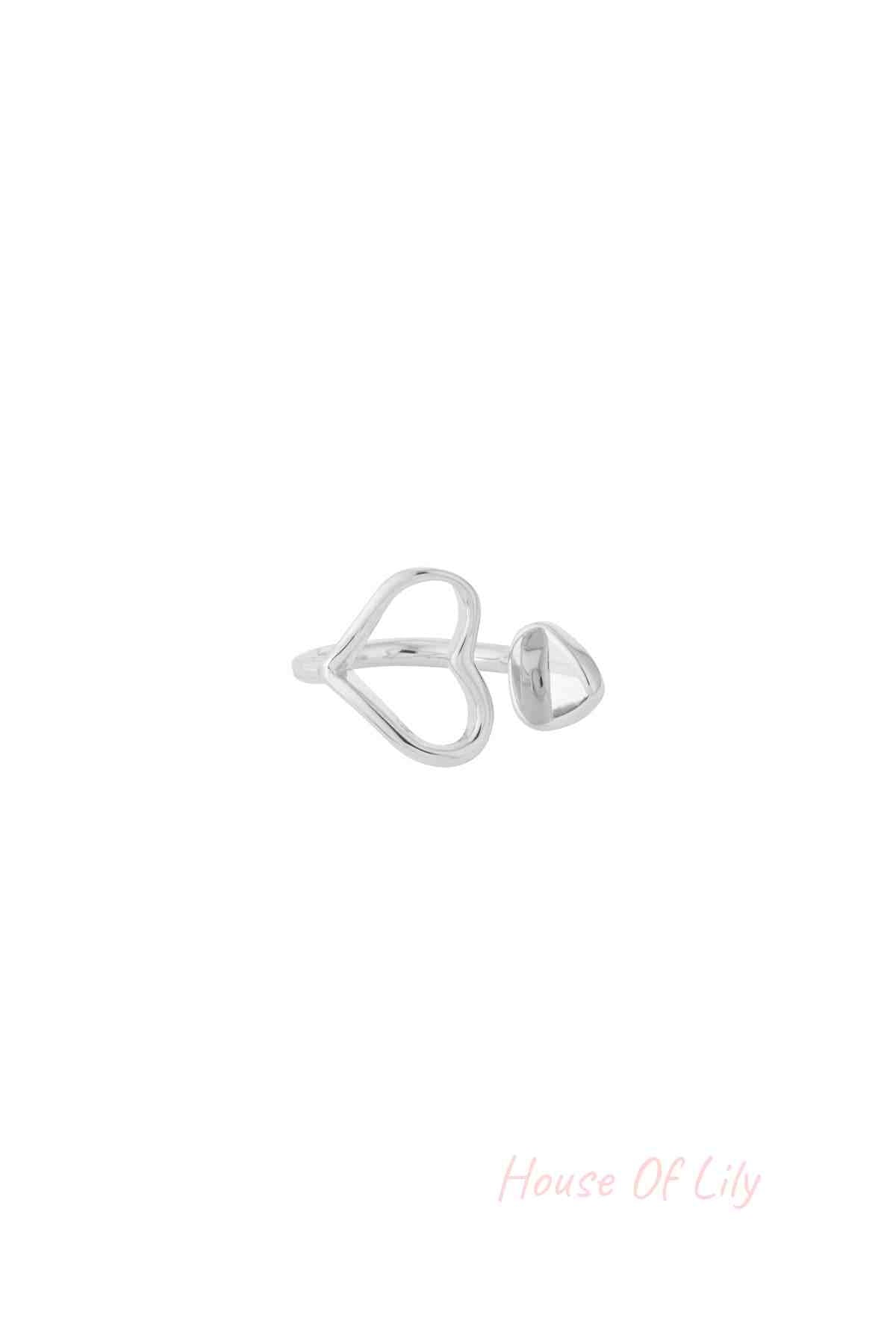 Silver-tone heart-shaped open ring with a small rounded end detail on white background