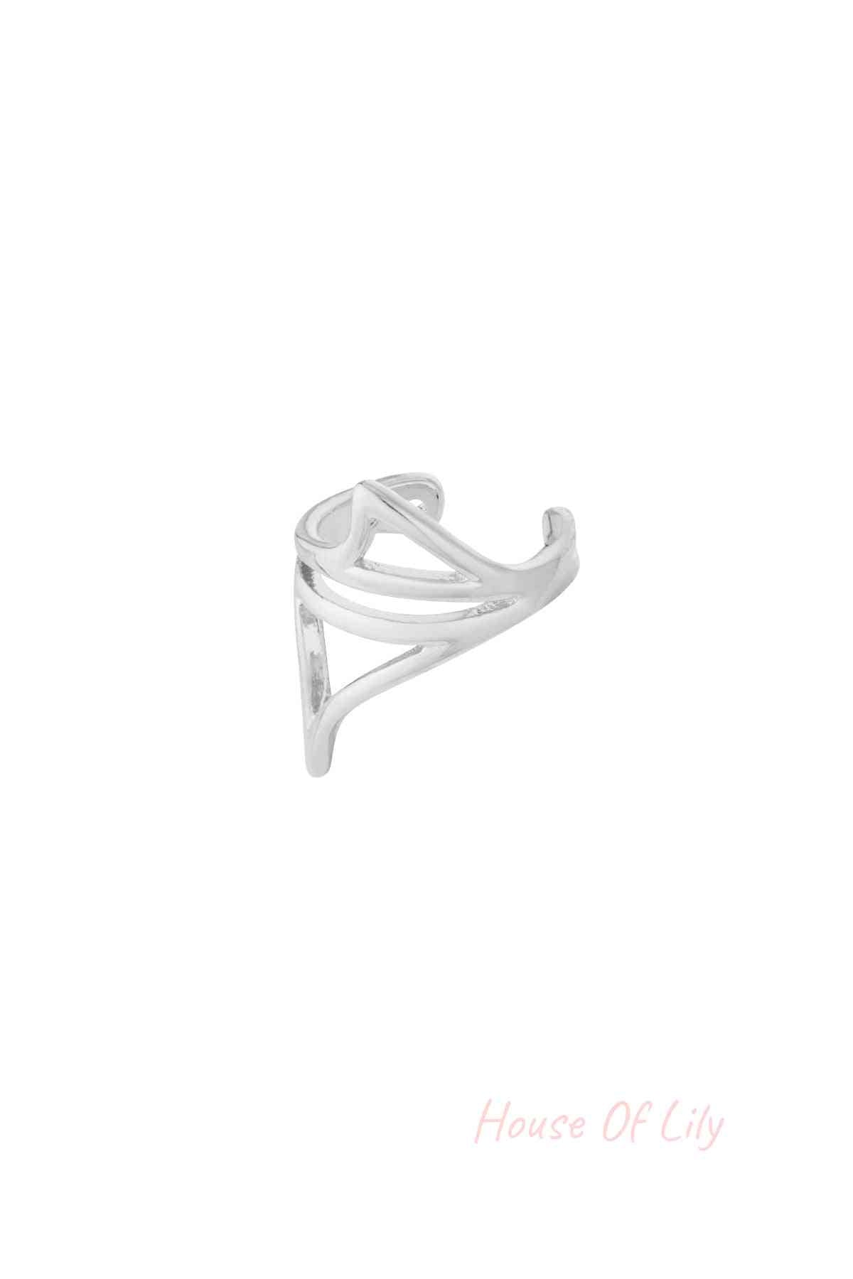Silver-tone geometric ear cuff with open triangular design against white background