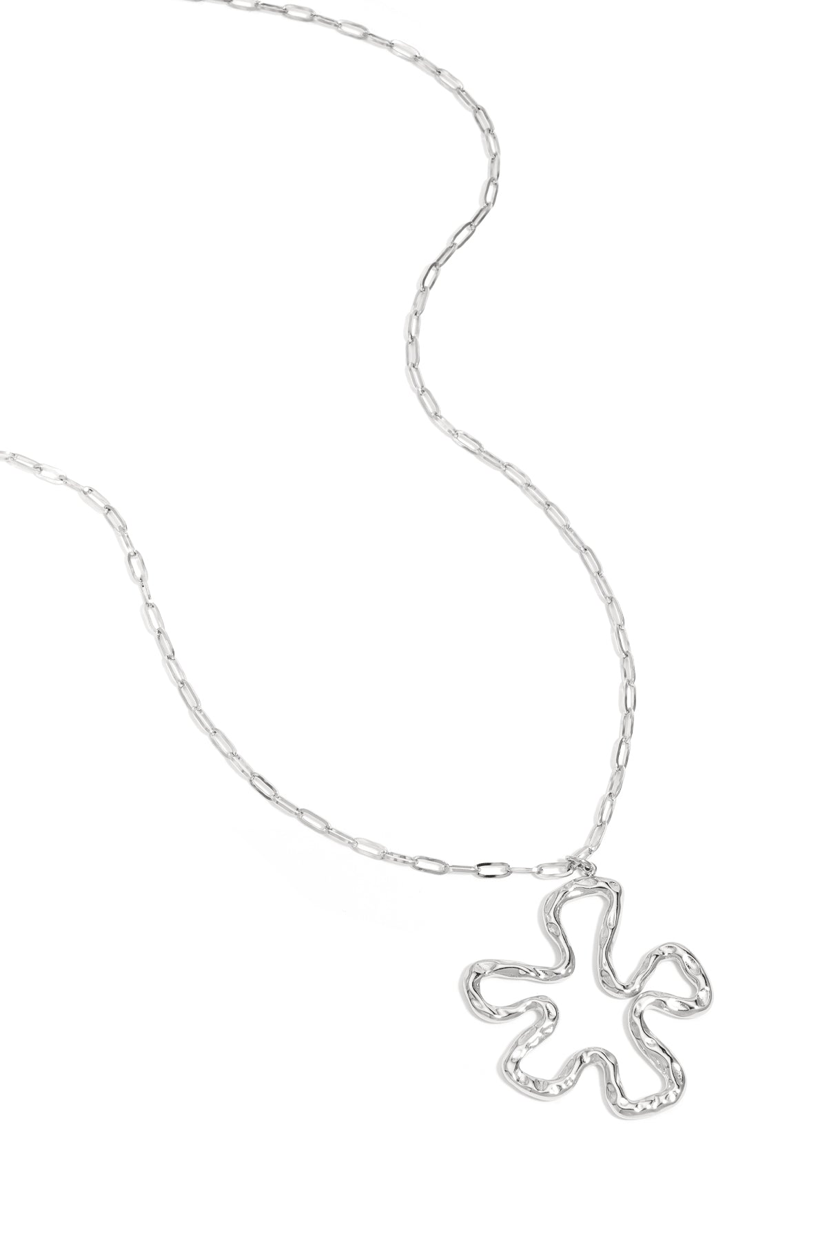 Silver version of the wavy abstract flower pendant necklace on white background with link chain visible