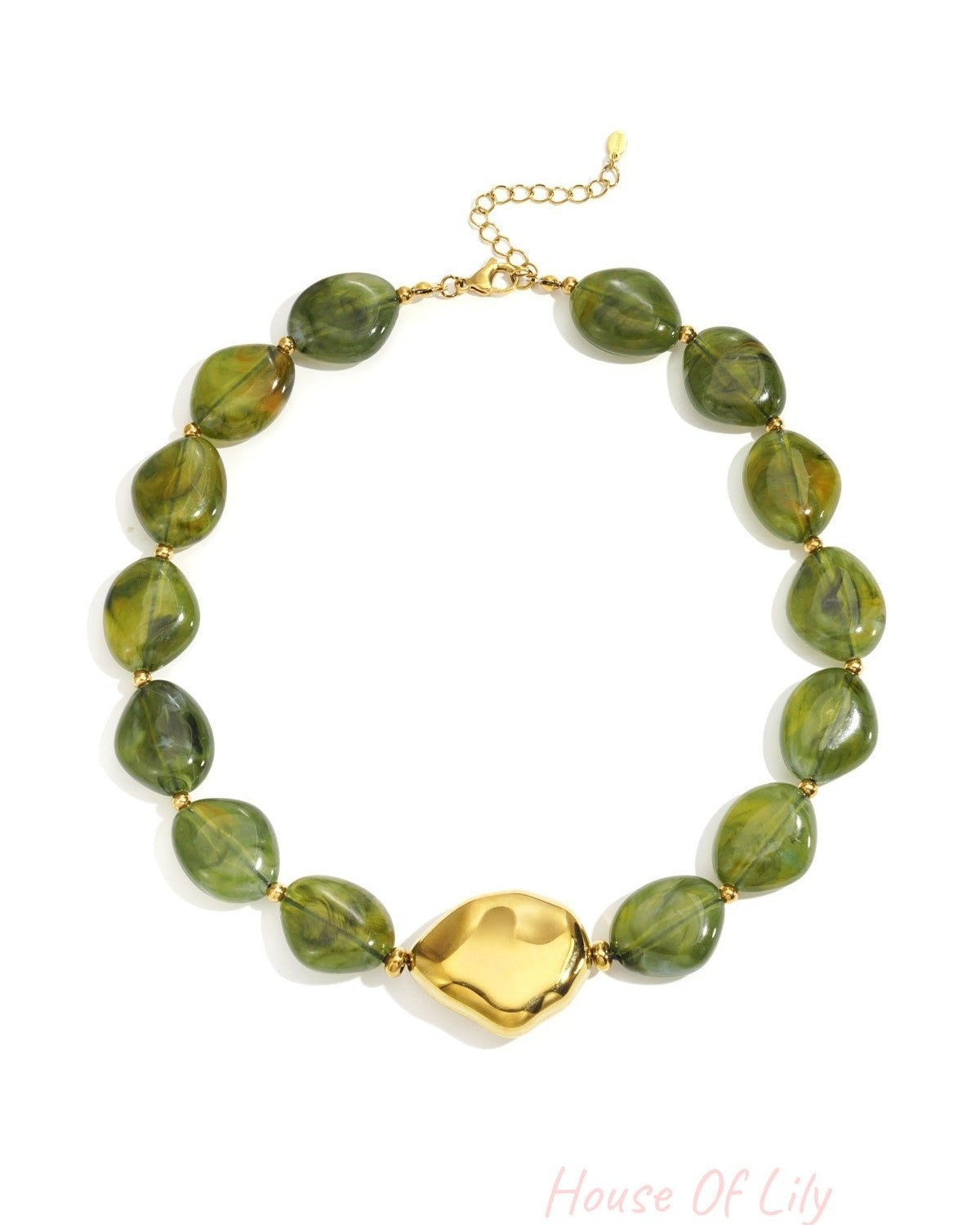 Flat lay image of earthy green acrylic beaded necklace with bold gold statement bead on white background