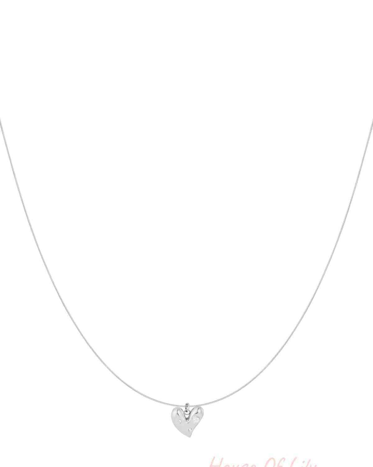 Minimalist silver heart pendant necklace with rhinestones on thin chain isolated on white background