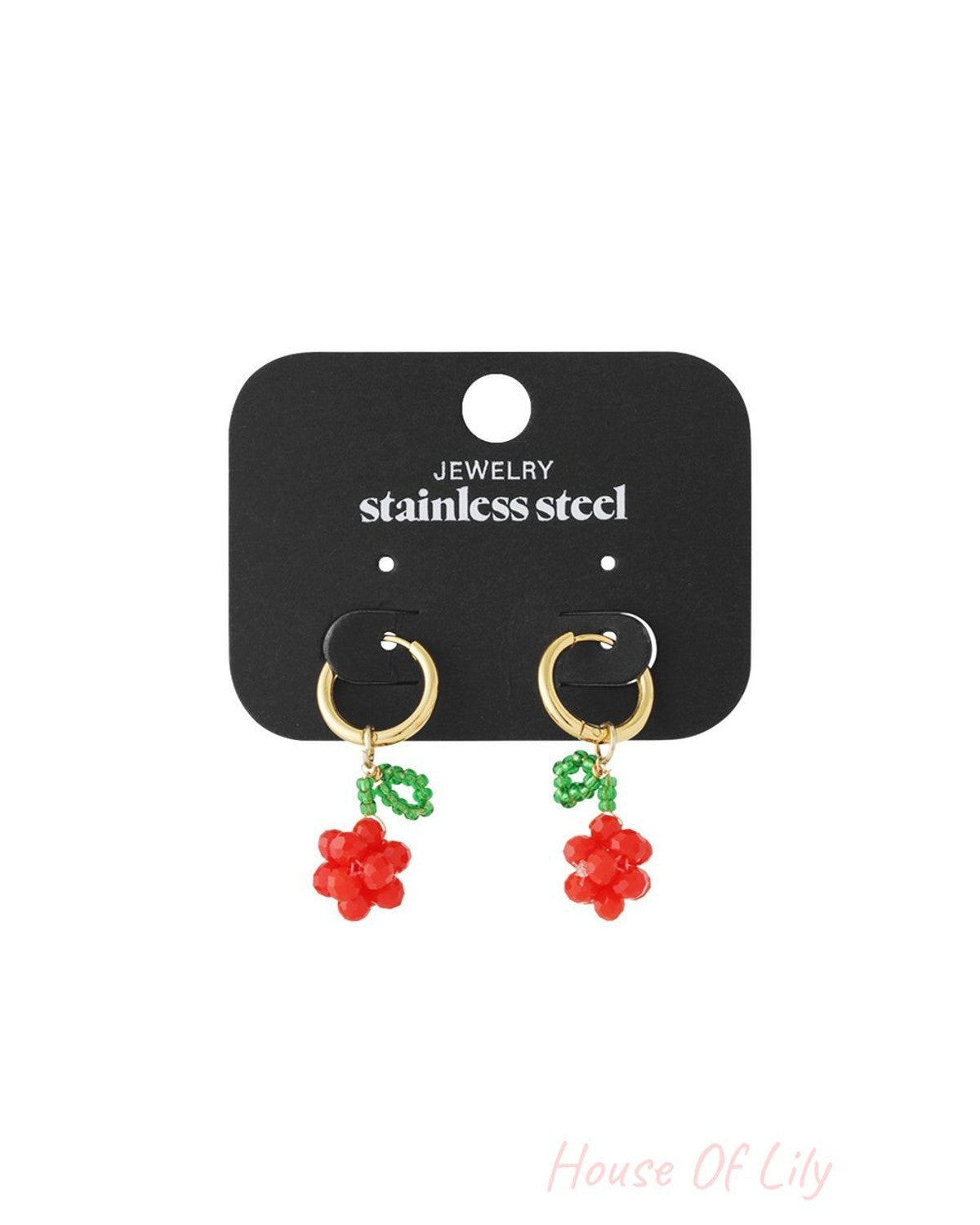 Gold hoop earrings featuring beaded red cherry charms with green leaves, displayed on a stainless steel jewelry card.
