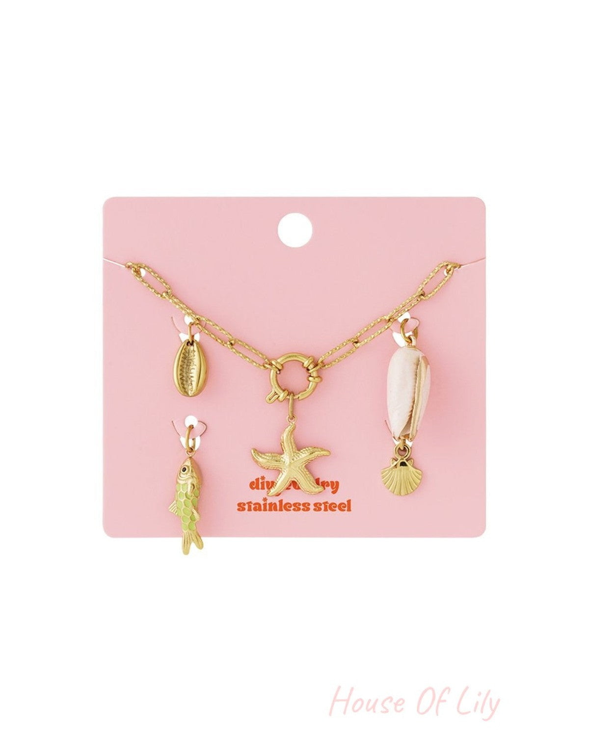 Golden Wave Vibe gold stainless steel chain bracelet featuring seashell, starfish, and green fish charms on pink card.