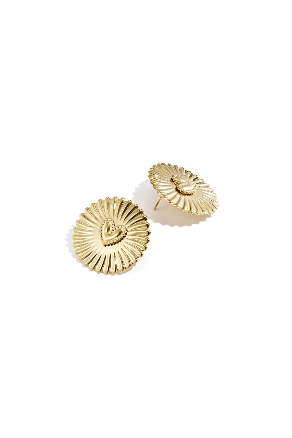 Gold stud earrings featuring a textured heart center on a sunburst-inspired, radial ridged disc.