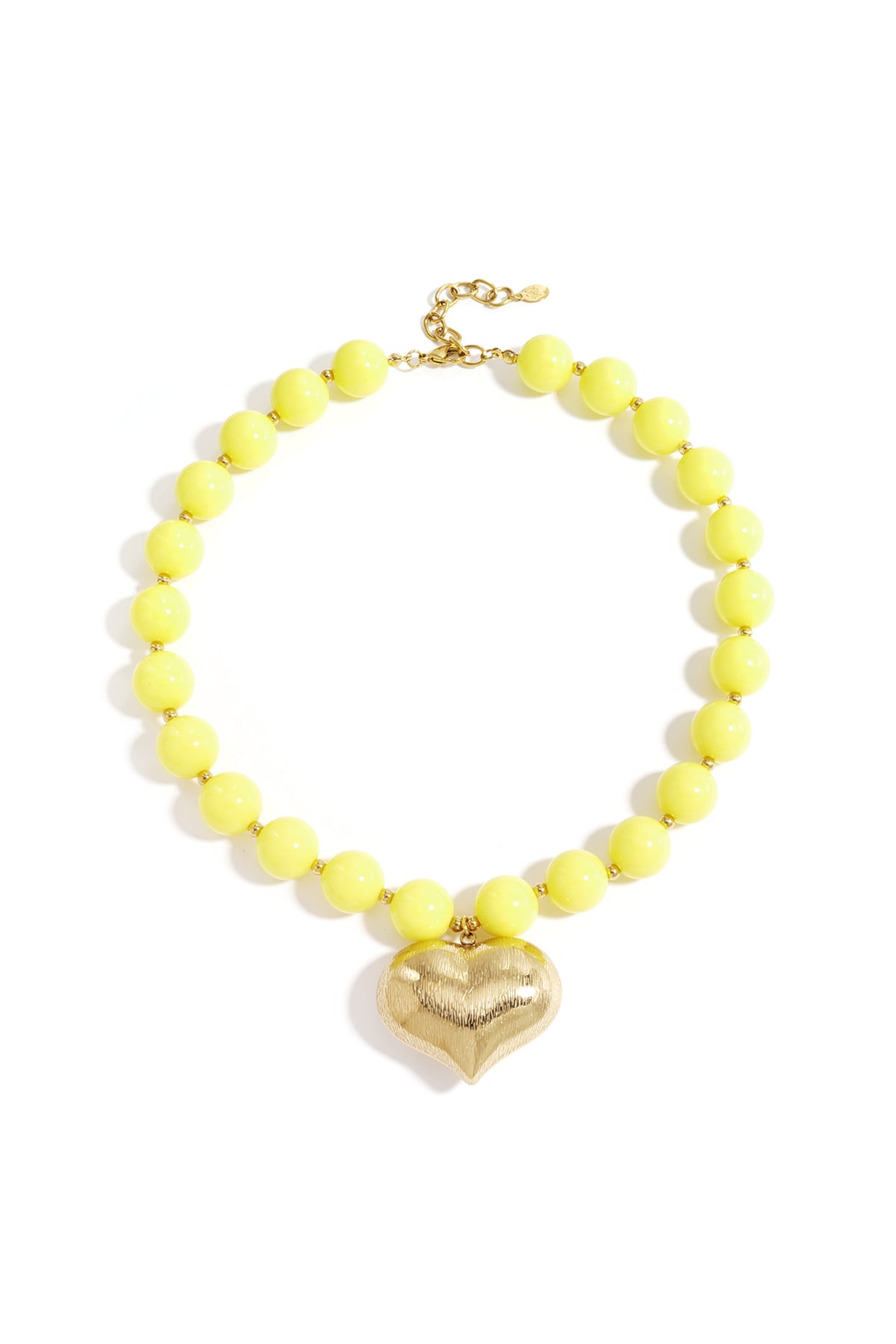 Chunky sunny yellow beaded necklace with textured gold heart pendant laid flat